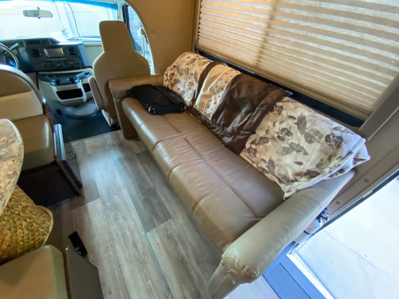 Couch with two seatbelts.  This pulls out to a bed. The dinette is opposite with two seatbelts and also folds into a bed.