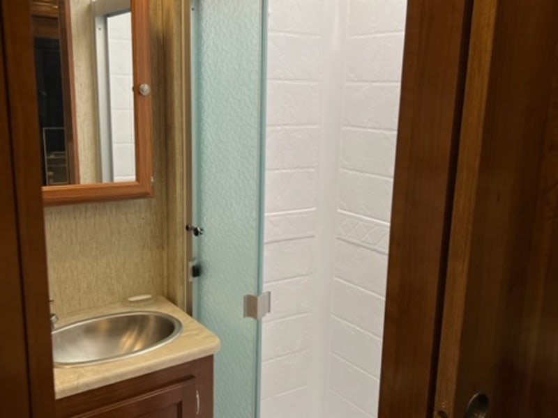 Tall, large shower with skylight and three panel sliding true glass door- showerhead has great pressure!