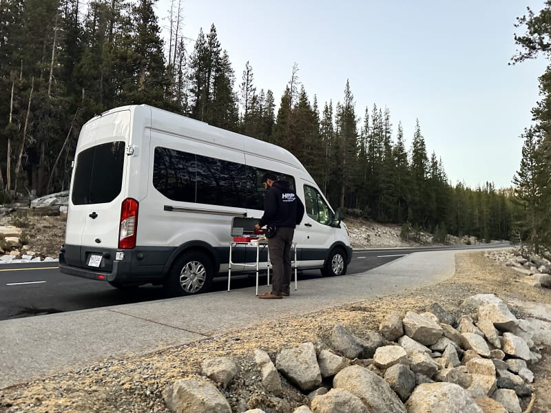 Photo of the campervan taken on a recent trip to Yosemite National Park with propane burners set up for outdoor cooking.