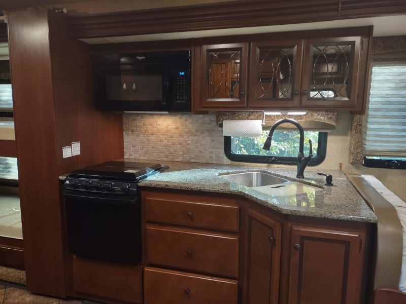 microwave/fan, stove/oven, and upgraded granite countertops with 60/40 sink