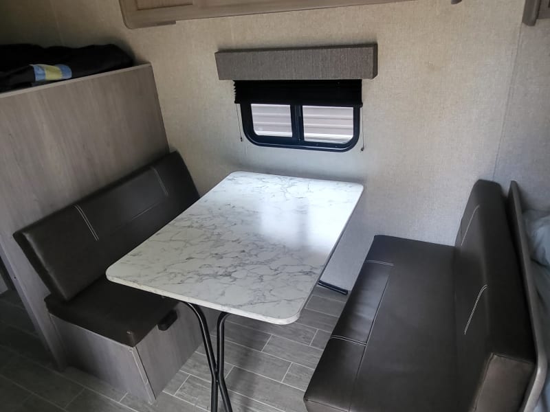 Dinette that folds into a bed.  Storage underneath the bench seats.