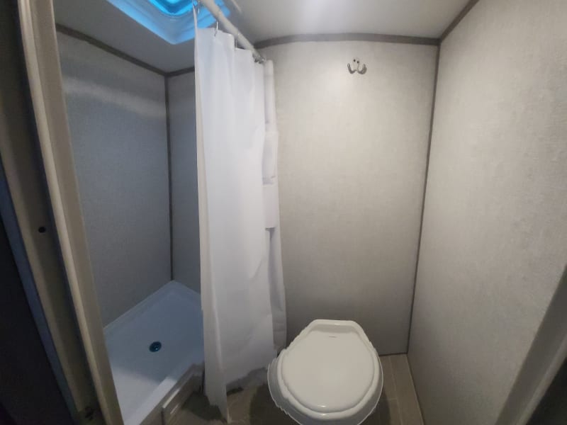 Bathroom (toilet and shower).  Camper has a single sink in the kitchen.