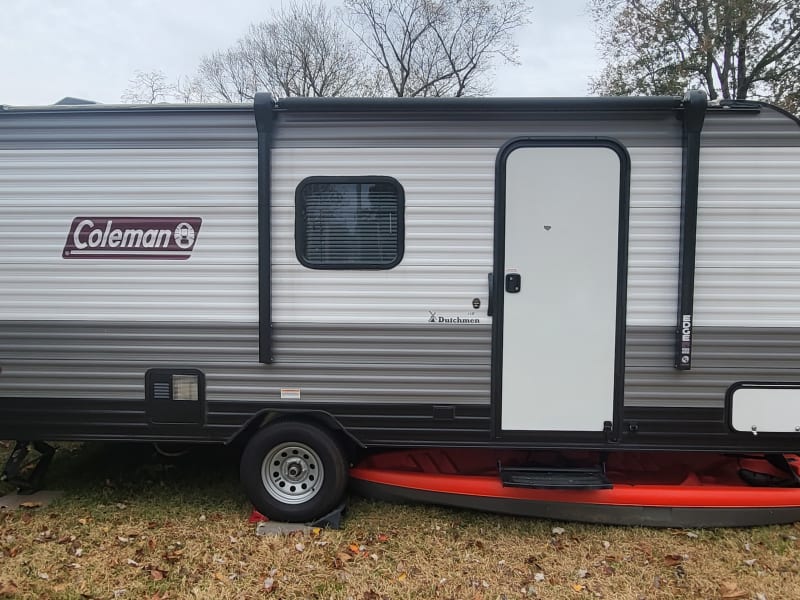 Side view of the camper with it parked in our yard.