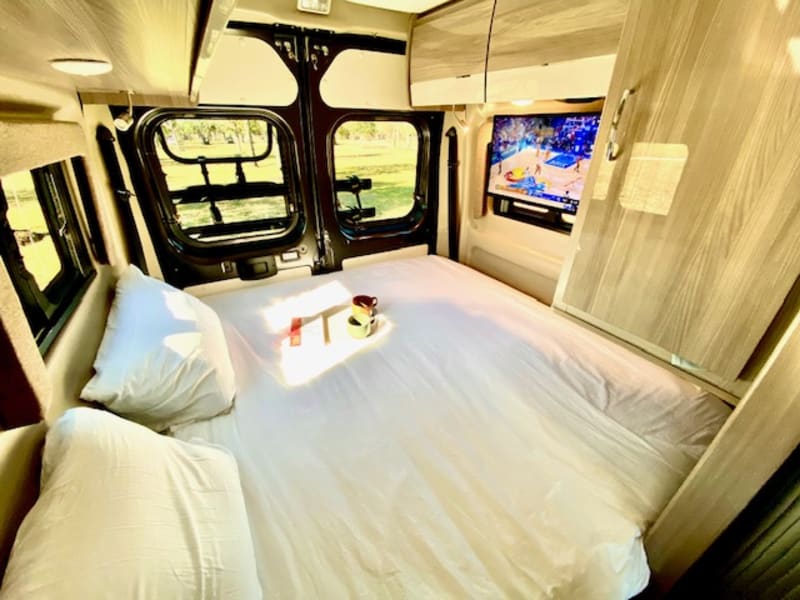 Rear RV King fold out bed is super comfortable. Comes with mattress topper, pillows, and all linens. Swing away TV is connected to an antenna booster.