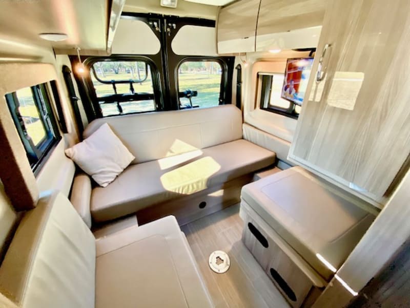 Fold the RV King sized bed away in the morning and it reveals the rear lounge area.  You can feel the gentle cross breeze with the side windows open.
