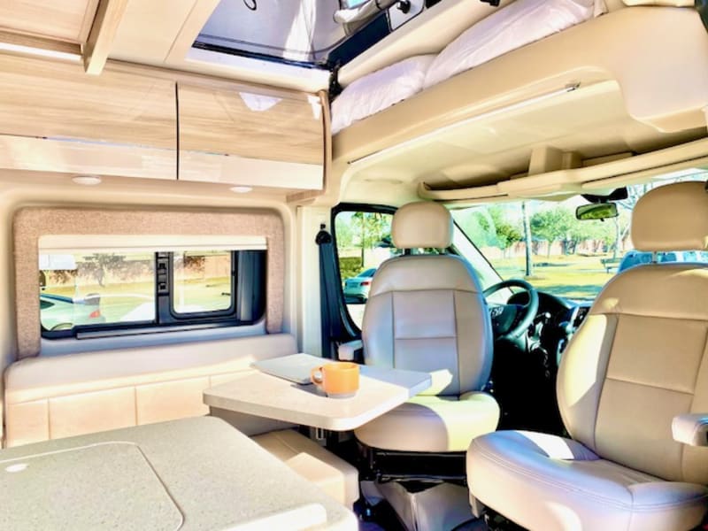 The van is equipped with a front (shown) and rear table that are both removeable for extra room in both lounge areas!
