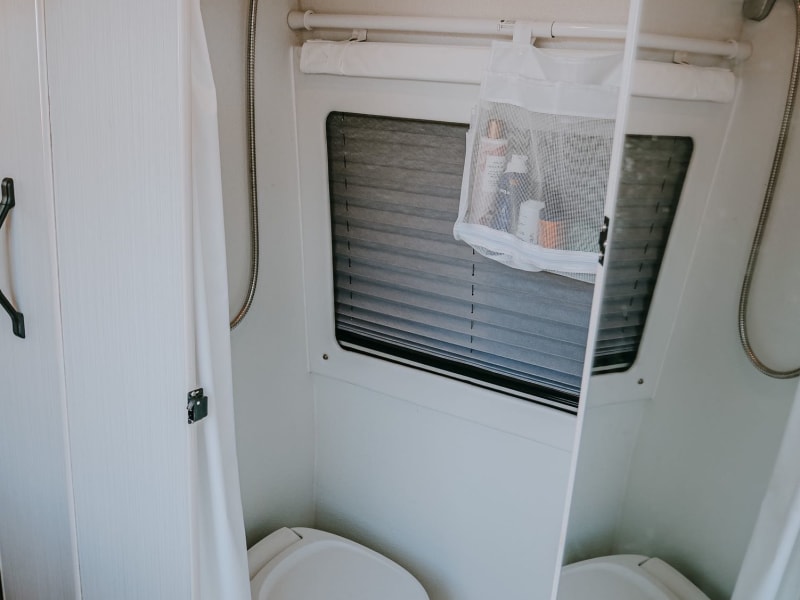 Full bathroom with a toilet and shower  