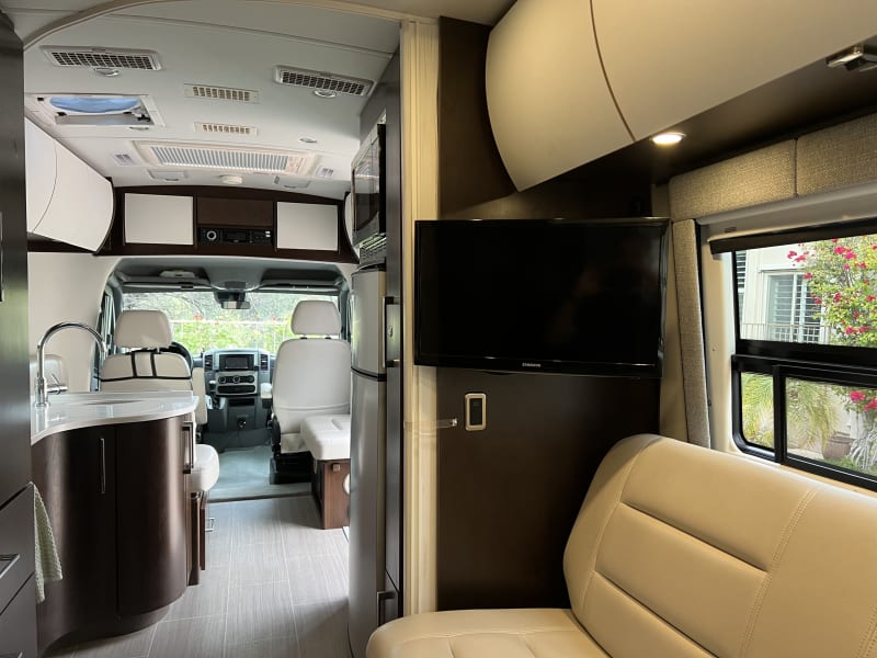 TV swivels towards the rear or front for viewing from the captain's chairs in front too. 
