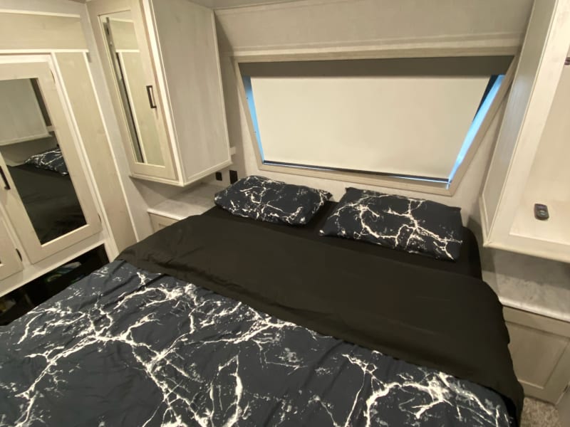 Master Bedroom with view out front with 4 door wardrobe and additional storage next to each side of the bed.