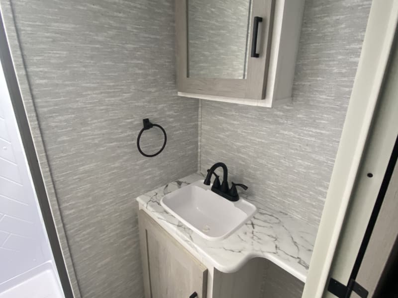Bathroom with upgraded sink and shower faucets.