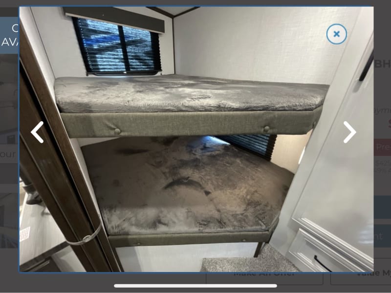 Double Full size bunks in rear of RV, with door that closes and a small closet.