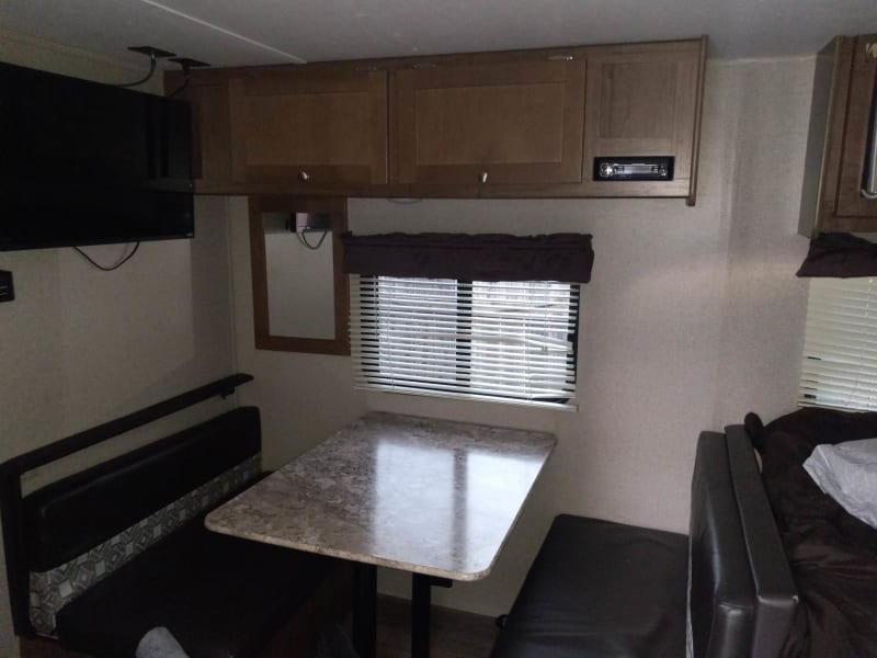 This dining table converts into a double size bed if needed. The TV and radio are overhead.