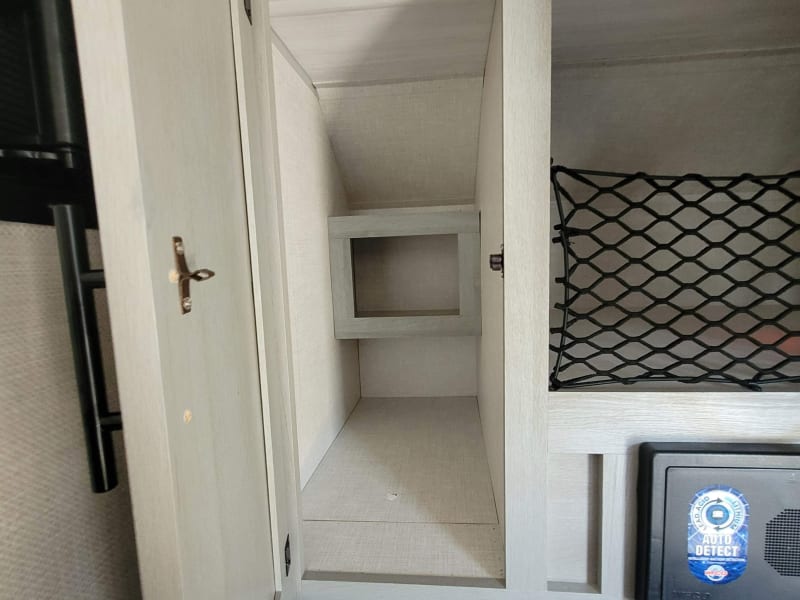 Cabinet for storage inside of the rig behind/ above bed/lounge. 