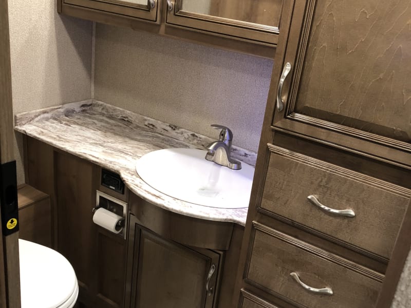 Full Bathroom 
Cabinets and storage drawers
Sink 
Bathroom has vent with cover above - one button operation 