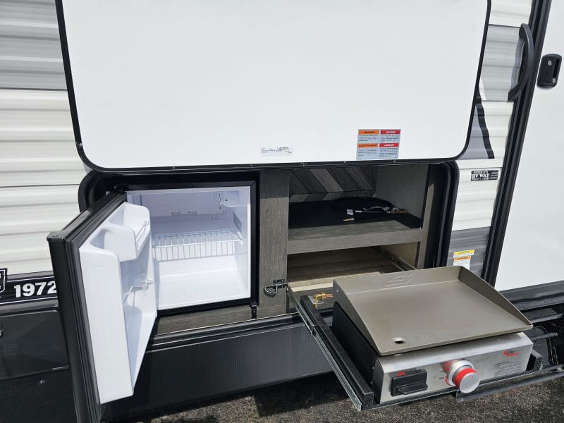 Outdoor refrigerator and flat top grill for those easy access grilling nights.