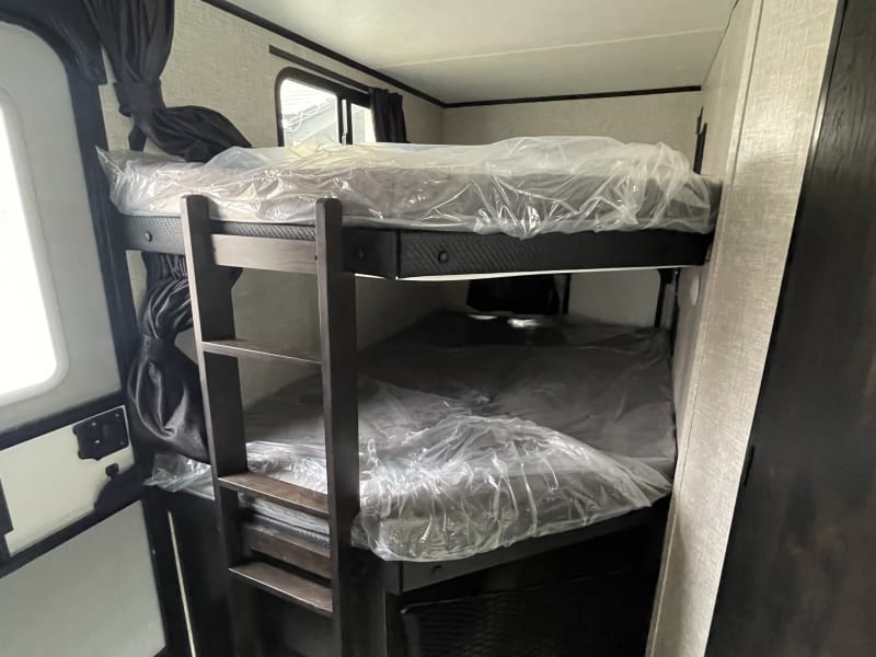 Bunk beds and lower storage area with net.