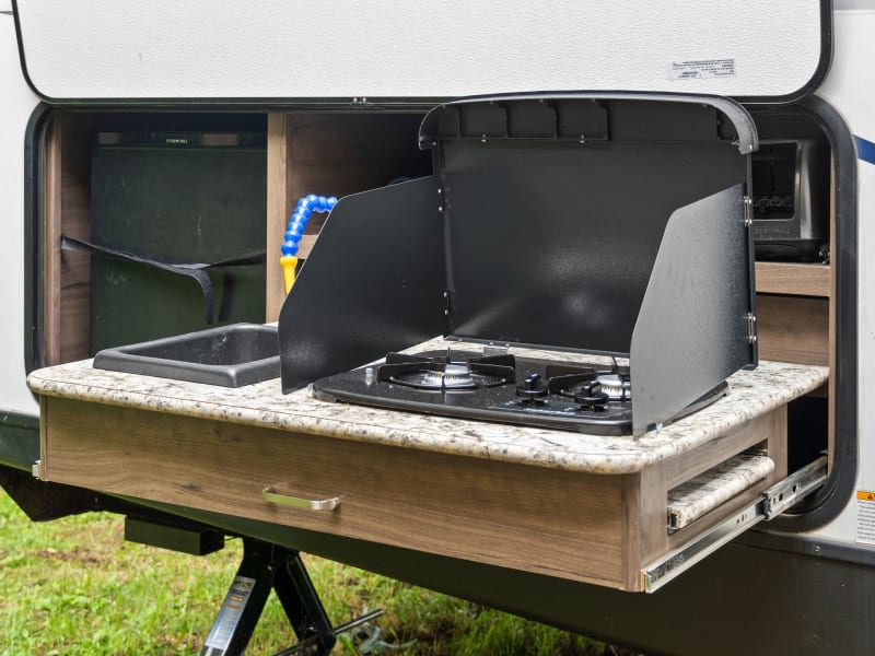 Want to cook outside? Enjoy this mini outdoor kitchen with mini fridge.