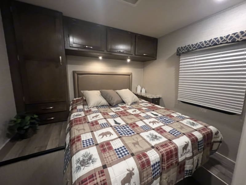 Master bedroom with wall around bed and lots of storage. 