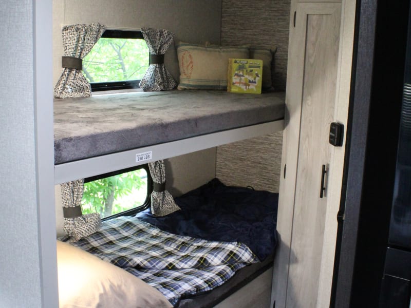 Twin Bunks that each fit a sleeping bag. Both beds have a window and night light. Sleeping bags, pillows, and blankets are not included. 
