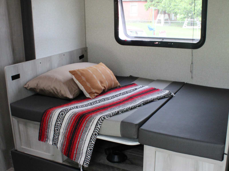 The dinette folded down to make a comfortable twin size bed. Blankets and pillows are not included. 