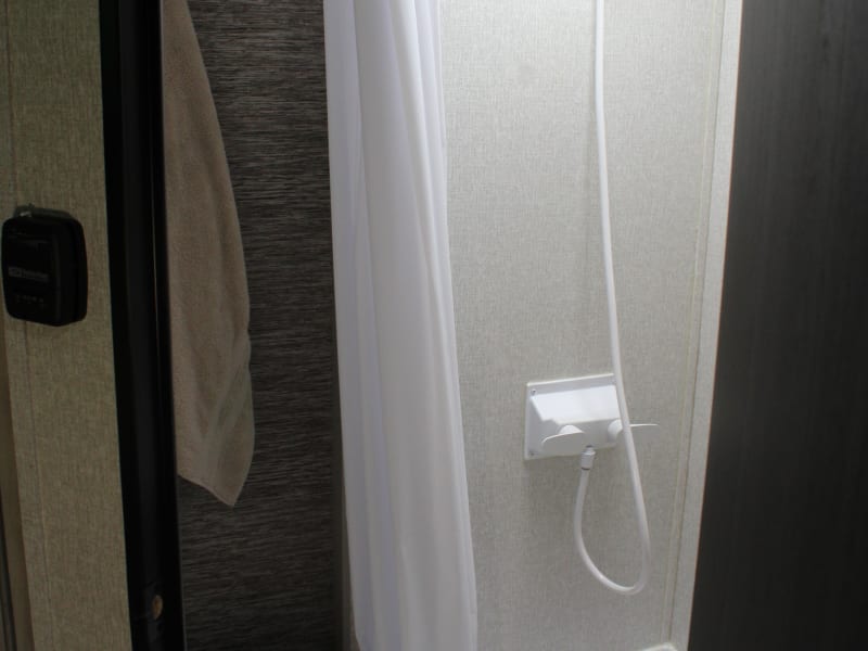Towbee's dry bathroom is small but mighty - featuring a walk in shower, flushing toilet, and a vanity / medicine cabinet combo!