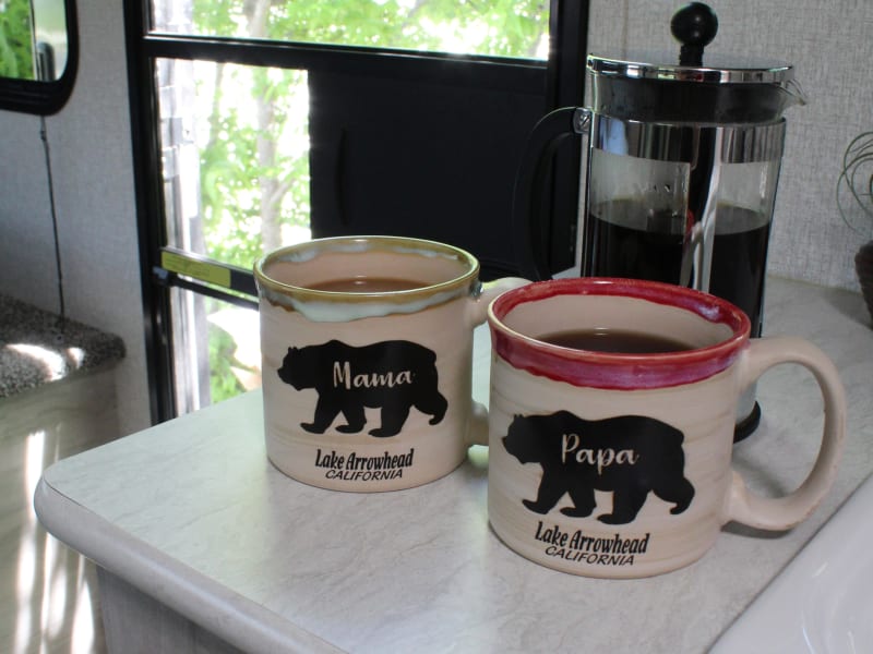 Coffee, cups, a kettle, and a coffee press can be found in the kitchen cupboards to make your morning a delight. Camp coffee always tastes better! 