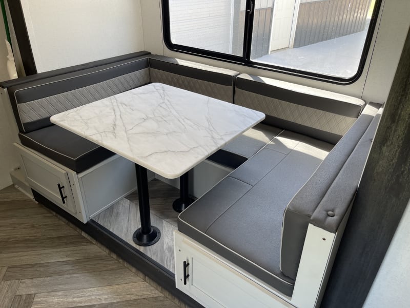 Dinette converts into a queen bed and also has storage underneath.