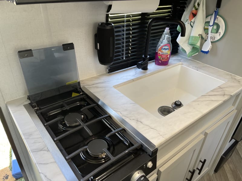 Kitchen includes microwave, fridge, freezer, sink, 2 burner gas stove, and all the essentials!