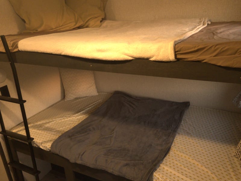 All beds have 1 standard sleeping pillow (not pictured), bed sheets, and a blanket.