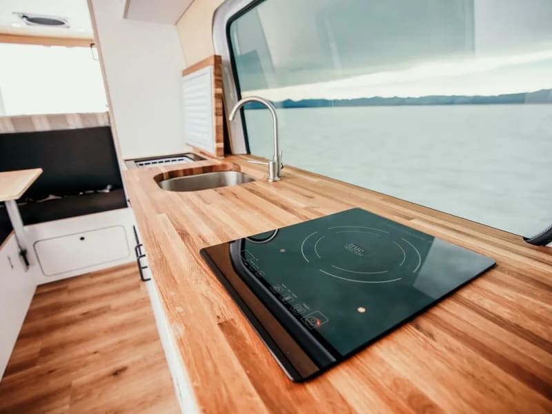 Induction stove, sink and fridge. Fully equipped kitchen. 