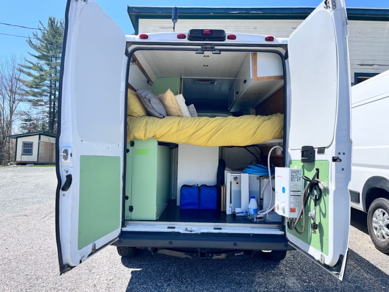 Rear storage, fresh water tank, and outdoor shower. 