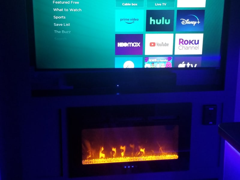 Fireplace and AM/FM/Bluetooth sound bar below TV