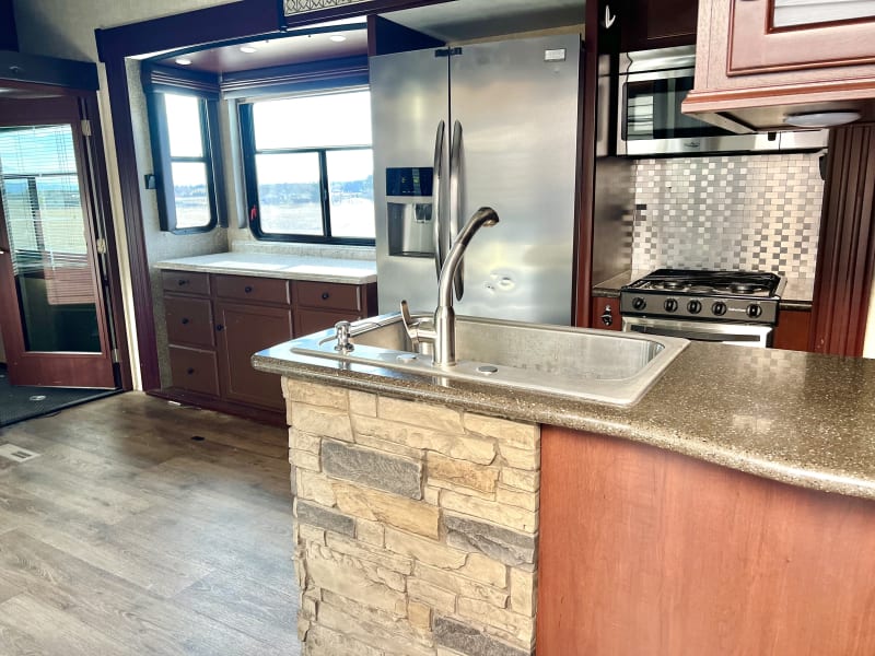 Very functional kitchen with full size fridge and lots of cupboard storage