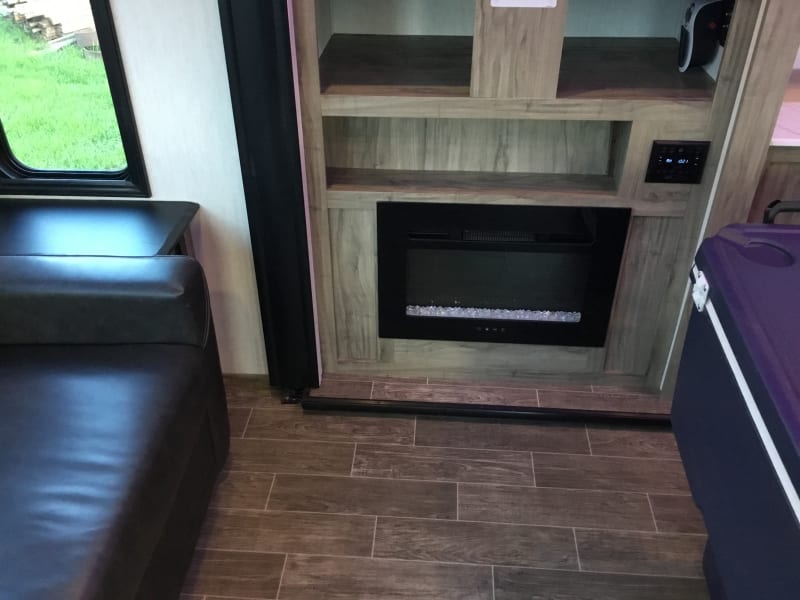 Electric heater fire place warms the room for indoor chilly day activities 