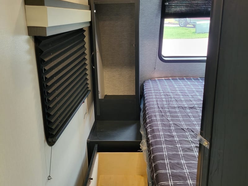 Master bedroom wardrobe storage with under bed drawer and shoe storage.