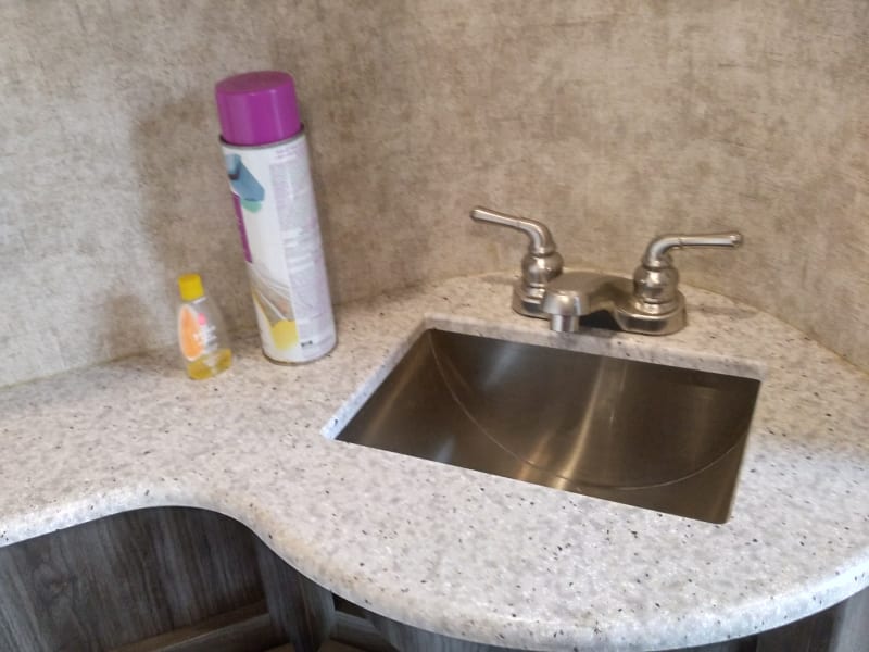 Bathroom stainless sink. Thee is a medicine cabinet above and storage below. we supply the toilet paper and chemicals for the holding tanks