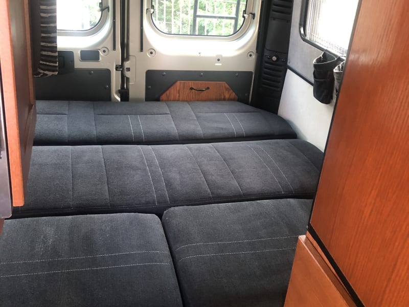 This shows the seat folded down to form the bad. It is designed for people to sleep crossways, with head and feet to the sides of the RV.