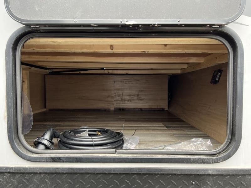 Outside storage access under queen bed. 