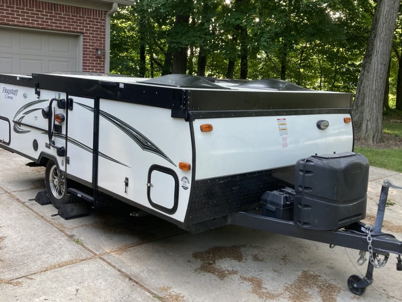 Folds down into an easy-to-tow little camper.  Deep cycle battery can charge with solar and run all the lights and fridge while off grid.