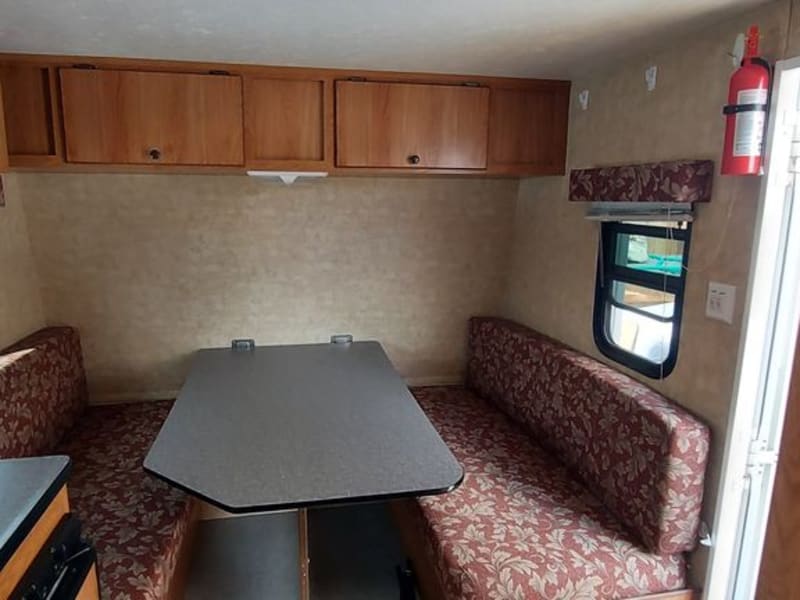 Dinette converts to queen bed.  Storage under right bench and water tanks under left.  Air conditioning is top left.