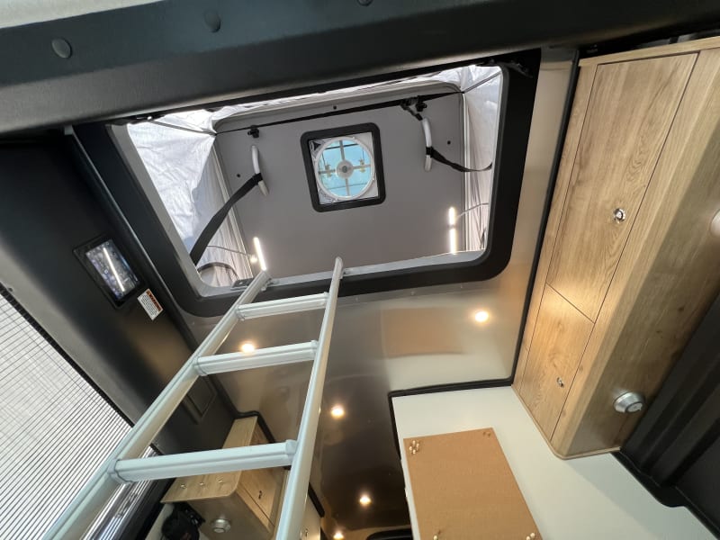 This is the entry and exit to the pop top sleeper. The vent fan shown helps to draw cool or warm air up to the sleeping area.