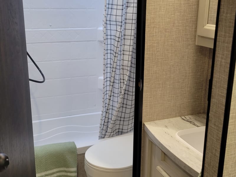 Shower/tub and toilet with a door for privacy