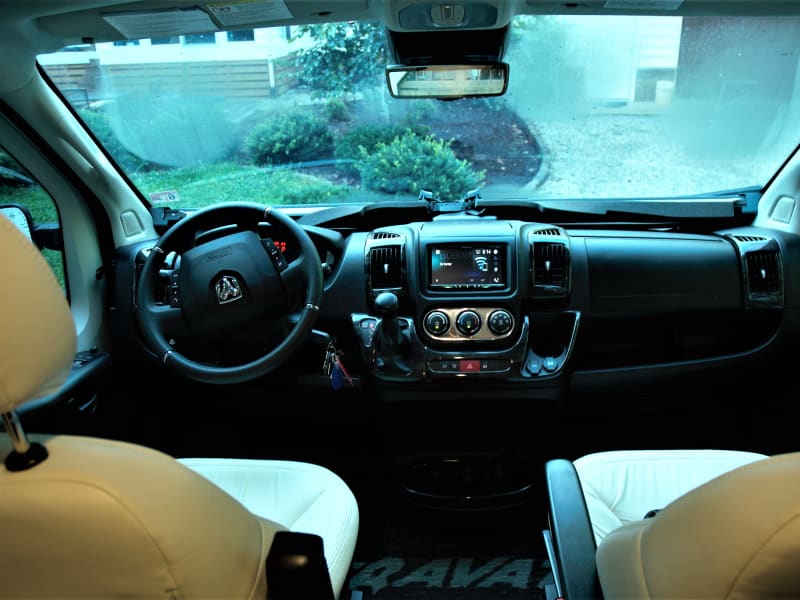 Driving cockpit. The chairs to turn around to face the kitchen and sleeping quarters. 