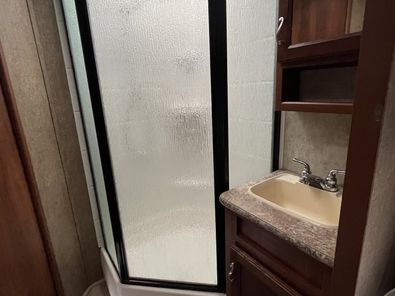 Bathroom has a shower with full glass surround, and 7 gallon water heater allows enough time for you get all showered up! 