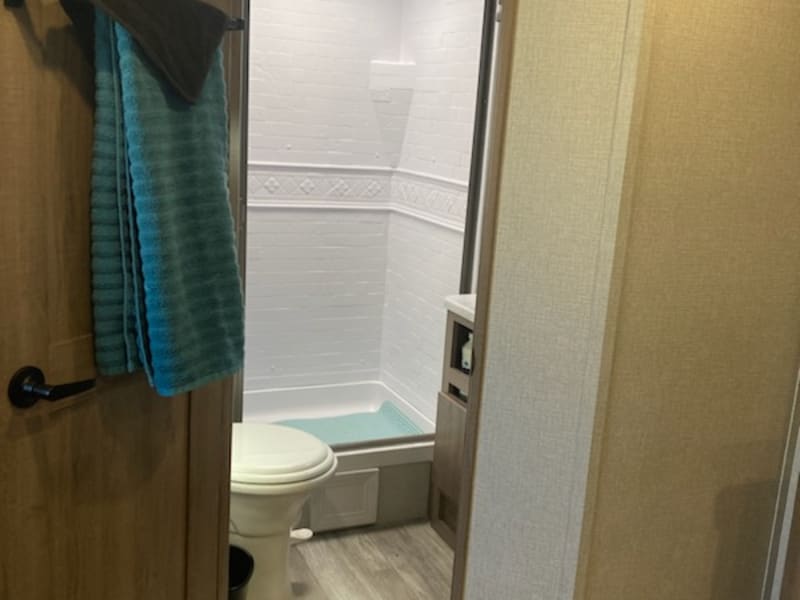 large bathroom with oversized shower and porcelain toilet 