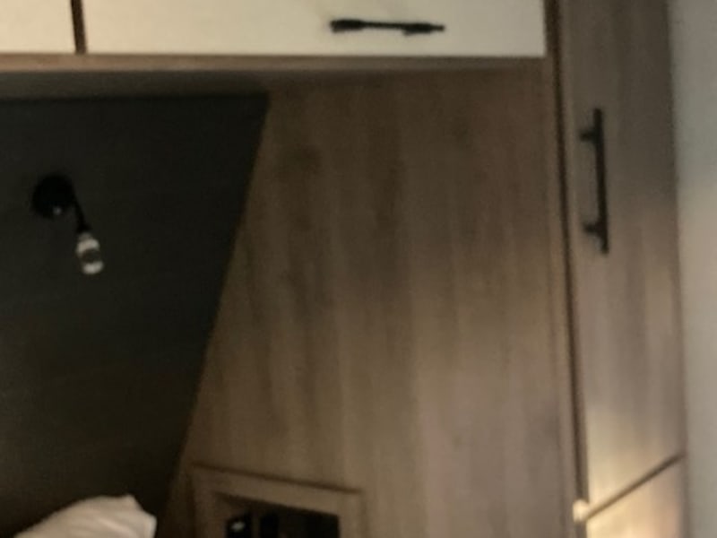 There are cubbies on both sides of the primary bed with power outlets and USB ports. 