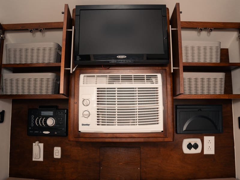 Cabinets in cabin equipped with baskets. We find the rolling method of folding clothing works best to optimize the storage area in the baskets.