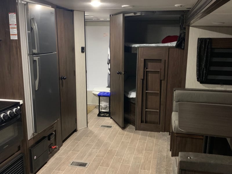 You can see the bunk beds, fridge dining table