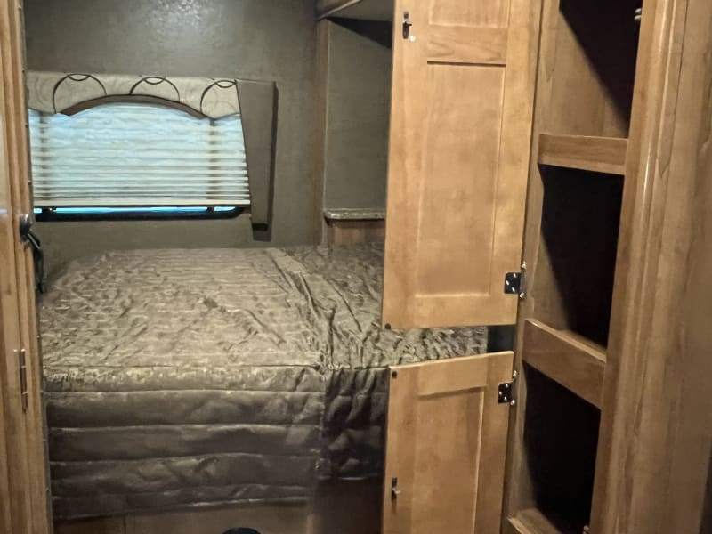 Large pantry cabinet at end of kitchen next to bedroom. The bedroom door slides out of the wall to close off bedroom for privacy if desired.