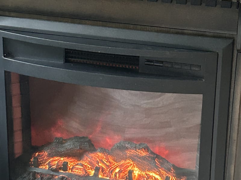 electric fireplace warms up the camper on cool mornings